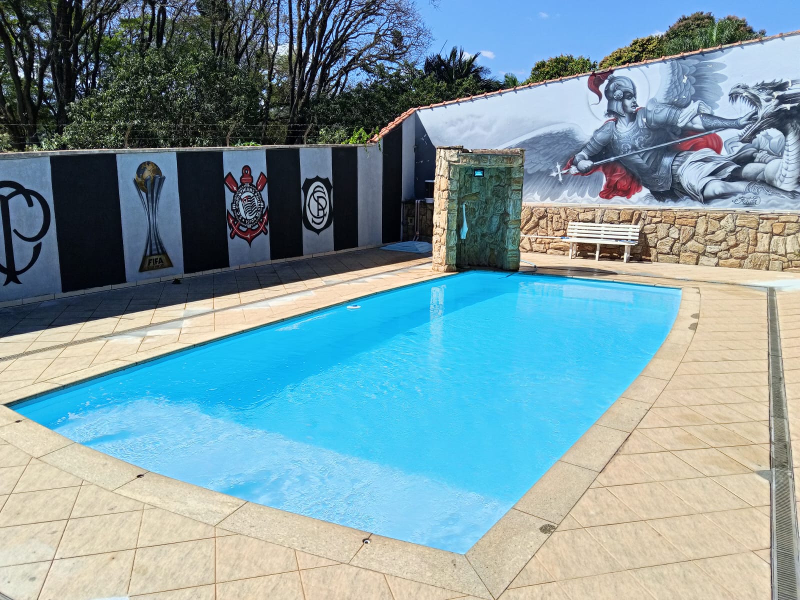 Piscina com área de lazer e piso cerâmico
